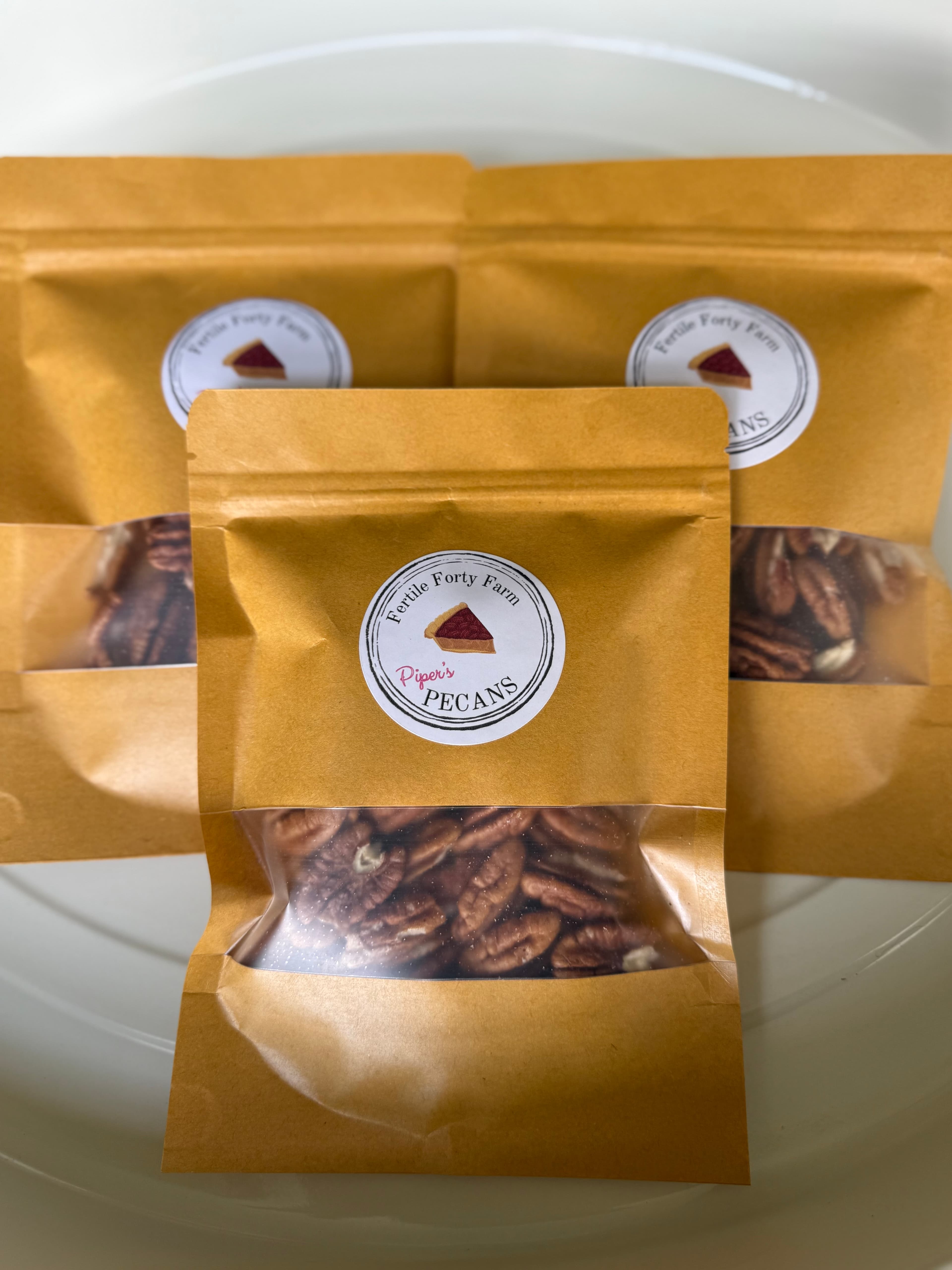 Fertile Forty Farm pecans packed in kraft bags with our Piper’s Pecans labels